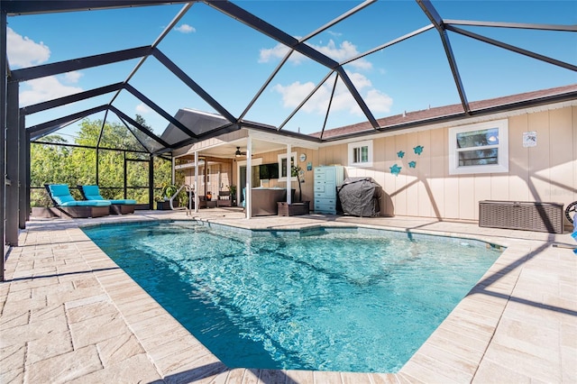 view of swimming pool featuring ceiling fan, a lanai, an outdoor hangout area, and a patio