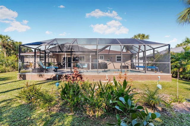 back of house with a lanai and a yard