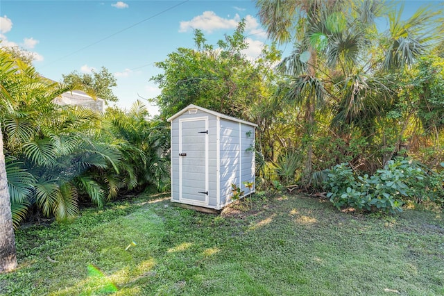 view of outdoor structure featuring a lawn