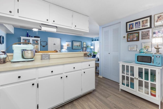 kitchen featuring white cabinets and wood-type flooring