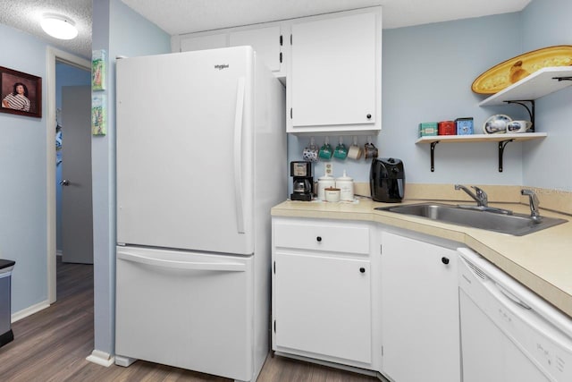 kitchen with sink, dark wood-type flooring, a textured ceiling, white appliances, and white cabinets