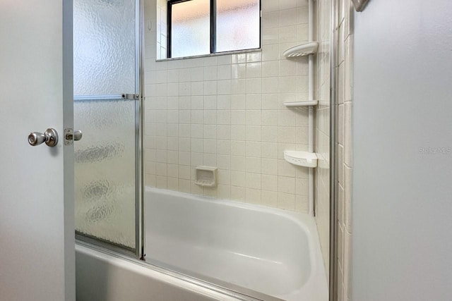 bathroom with shower / bath combination with glass door