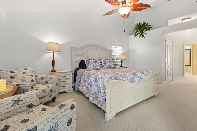 carpeted bedroom with ceiling fan and high vaulted ceiling