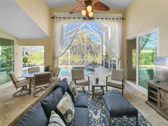 sunroom with ceiling fan and lofted ceiling