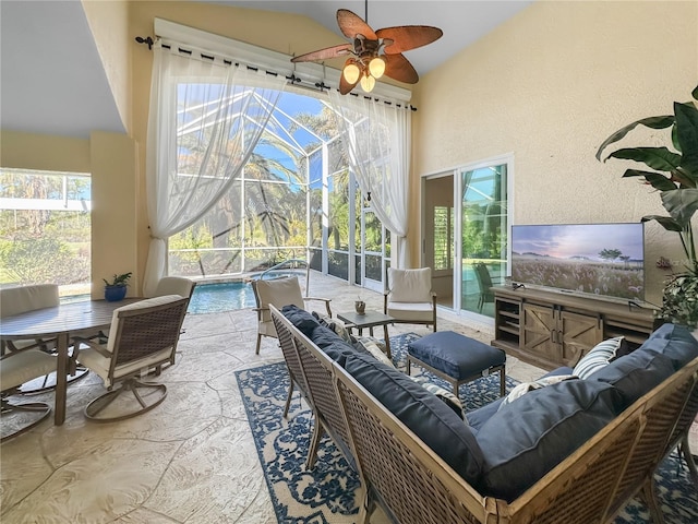 interior space featuring an outdoor living space, ceiling fan, and glass enclosure