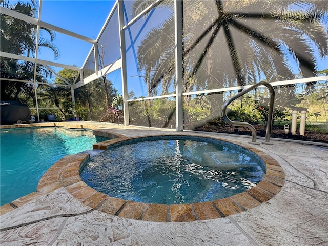 view of pool with an in ground hot tub, a lanai, and a patio area