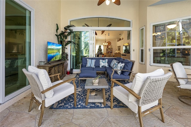 view of patio with ceiling fan and an outdoor living space