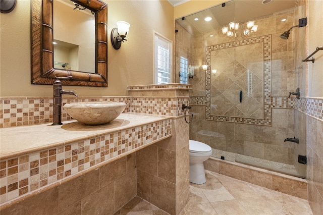 bathroom featuring sink, tile walls, an enclosed shower, tile patterned floors, and toilet