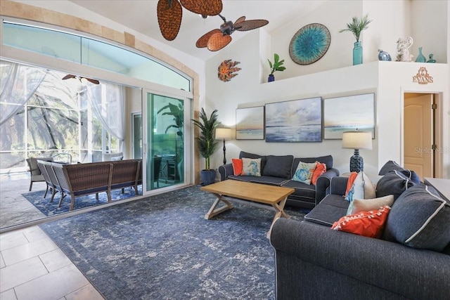 living room featuring ceiling fan, light tile patterned floors, and high vaulted ceiling