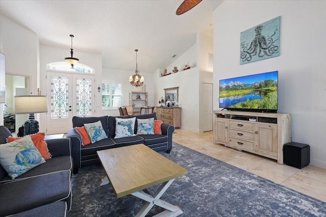 living room with french doors, a chandelier, and high vaulted ceiling