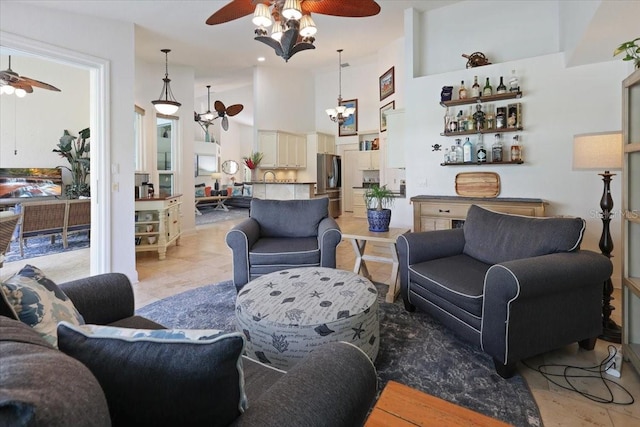 living room with a high ceiling and ceiling fan