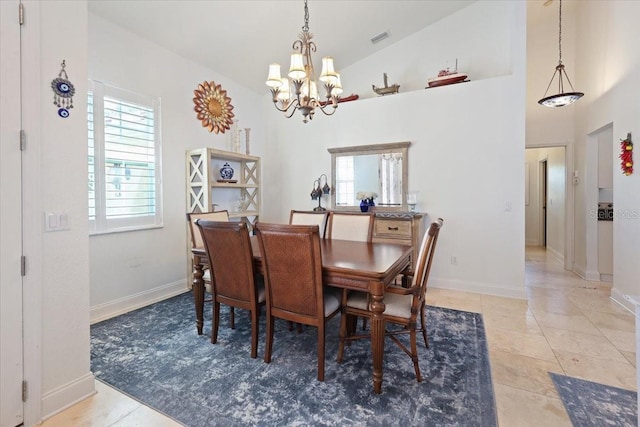 tiled dining room with a chandelier and high vaulted ceiling