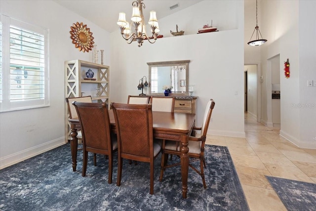 tiled dining space with a notable chandelier, vaulted ceiling, and a wealth of natural light