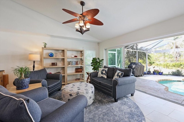 living room featuring vaulted ceiling, tile patterned floors, and ceiling fan