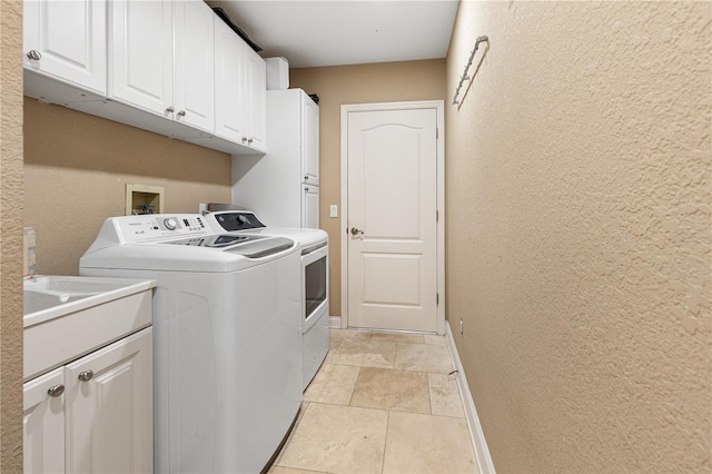 washroom with separate washer and dryer and cabinets