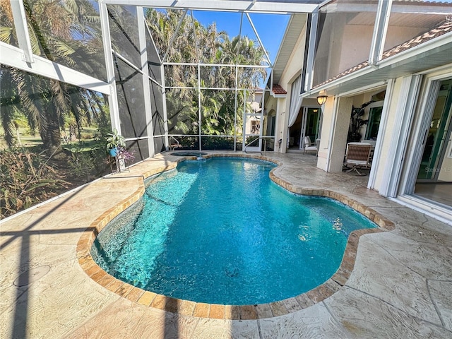 view of pool featuring a patio and glass enclosure