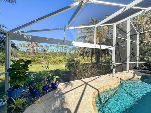 view of swimming pool with a lanai and a patio