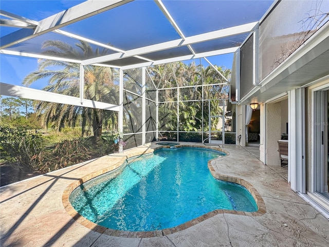 view of pool featuring a patio and glass enclosure