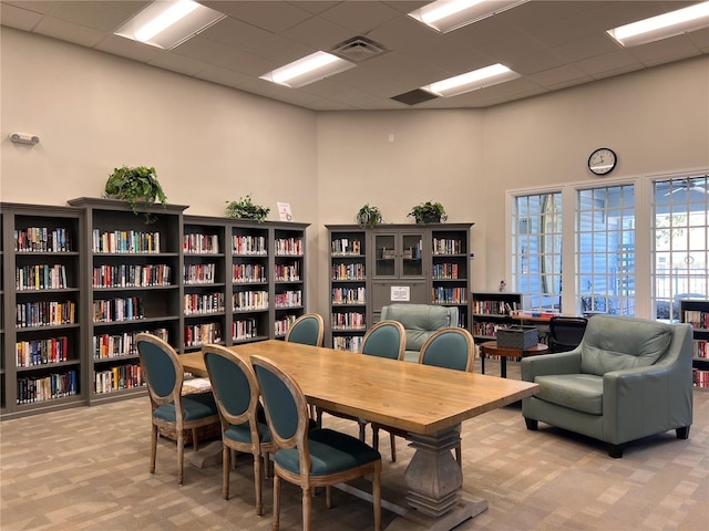 carpeted office featuring a drop ceiling