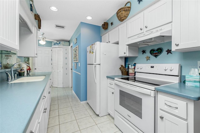 kitchen featuring white cabinets, white appliances, sink, and light tile patterned floors