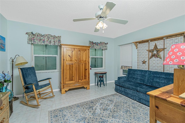 tiled living room featuring ceiling fan and a textured ceiling