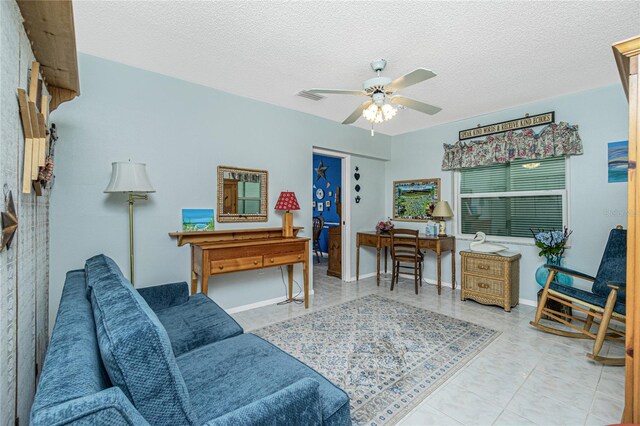 interior space featuring a textured ceiling, ceiling fan, and light tile patterned flooring