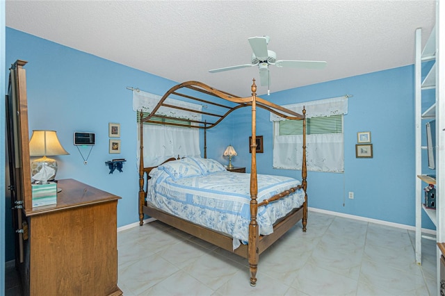 bedroom featuring ceiling fan and a textured ceiling