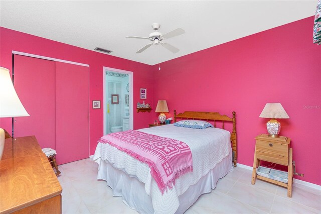 bedroom with light tile patterned floors, a closet, and ceiling fan