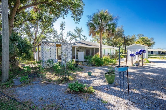 view of front of house featuring a storage unit