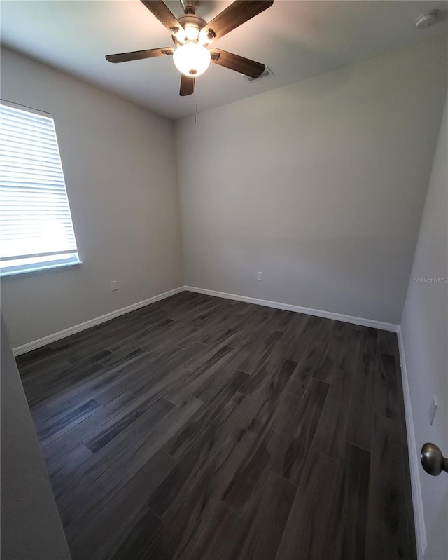 spare room with dark wood-type flooring