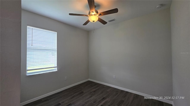 unfurnished room featuring dark hardwood / wood-style floors and ceiling fan