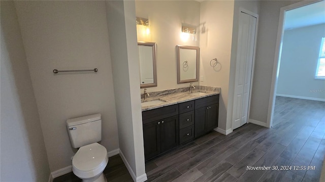 bathroom featuring hardwood / wood-style floors, vanity, and toilet