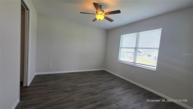 spare room with ceiling fan and dark wood-type flooring