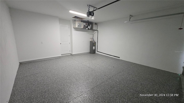 30072 Alder Rd, Punta Gorda, FL 33982 - garage featuring electric water heater and a garage door opener