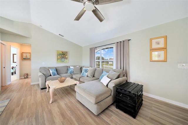 living room featuring ceiling fan, lofted ceiling, and light hardwood / wood-style flooring