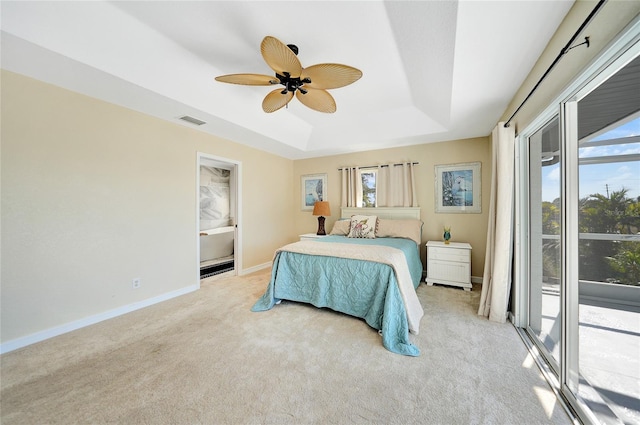 carpeted bedroom with a raised ceiling, ceiling fan, and access to exterior