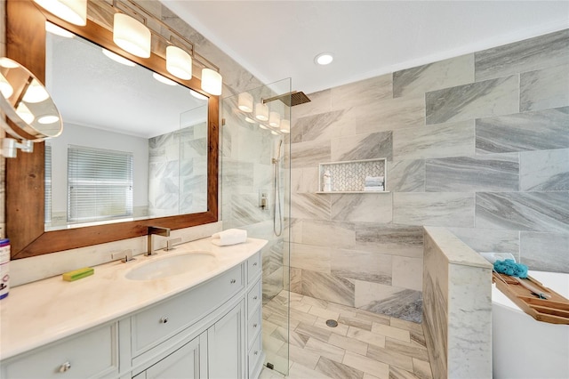 bathroom featuring a tile shower and vanity