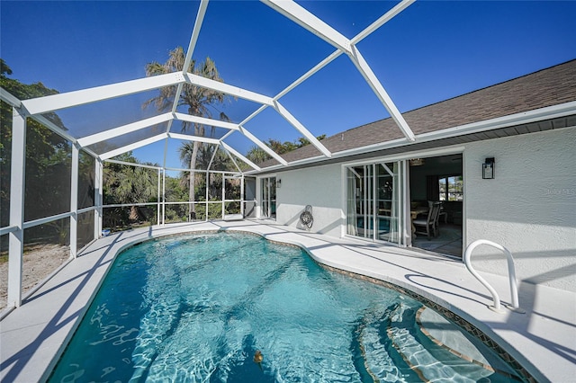 view of swimming pool featuring a patio and glass enclosure