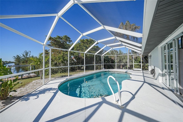 view of swimming pool featuring a patio, a water view, and glass enclosure