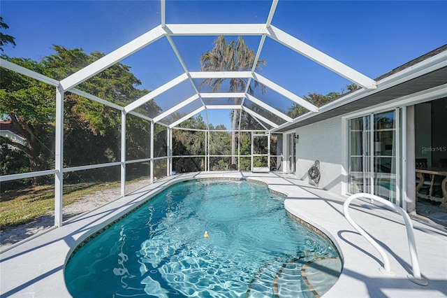 view of pool with a patio area and a lanai