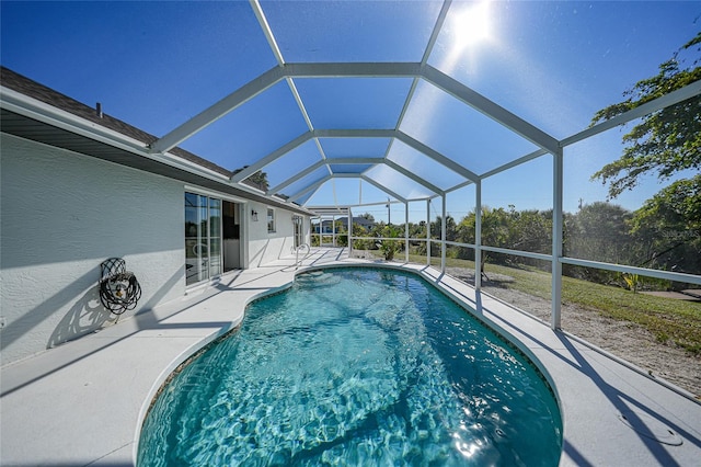 view of pool with a lanai and a patio