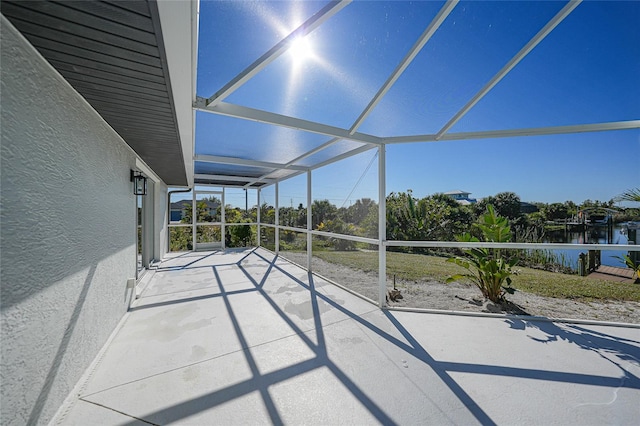 unfurnished sunroom featuring a water view