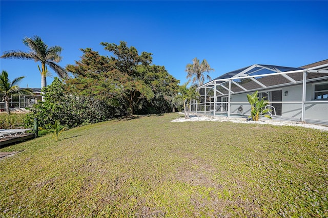 view of yard with glass enclosure