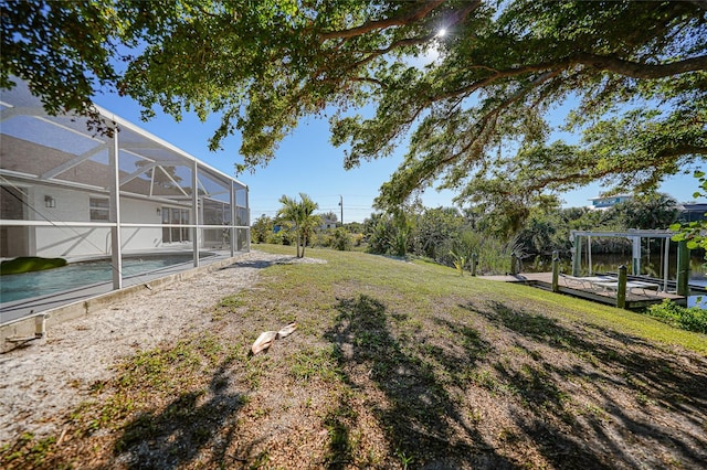 view of yard with a lanai and a swimming pool