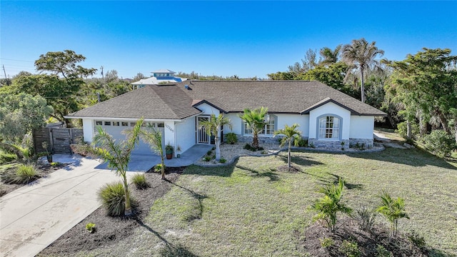 ranch-style house featuring a garage and a front lawn