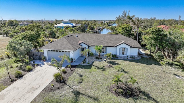 view of front of property with a garage and a front lawn