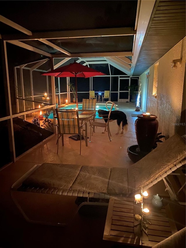 view of patio / terrace with a swimming pool with hot tub and a lanai