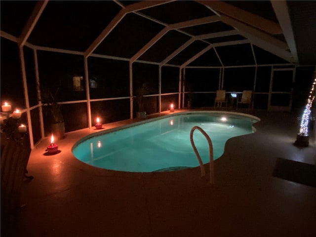 view of swimming pool with a patio and glass enclosure