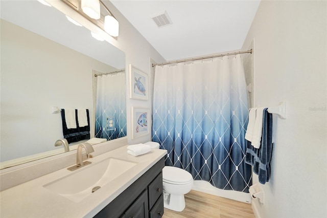 bathroom with hardwood / wood-style floors, vanity, toilet, and a shower with curtain