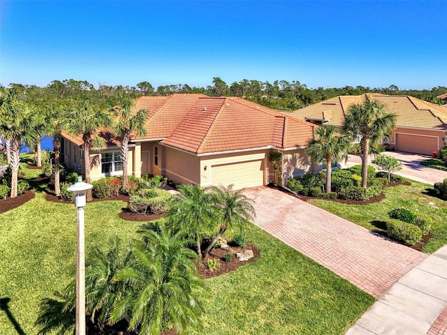 mediterranean / spanish house with a garage and a front yard